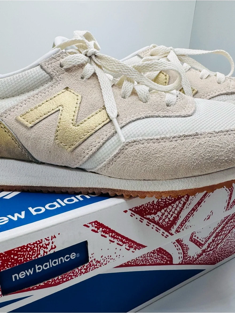 New Balance Women’s White Sneakers with Gold Accents